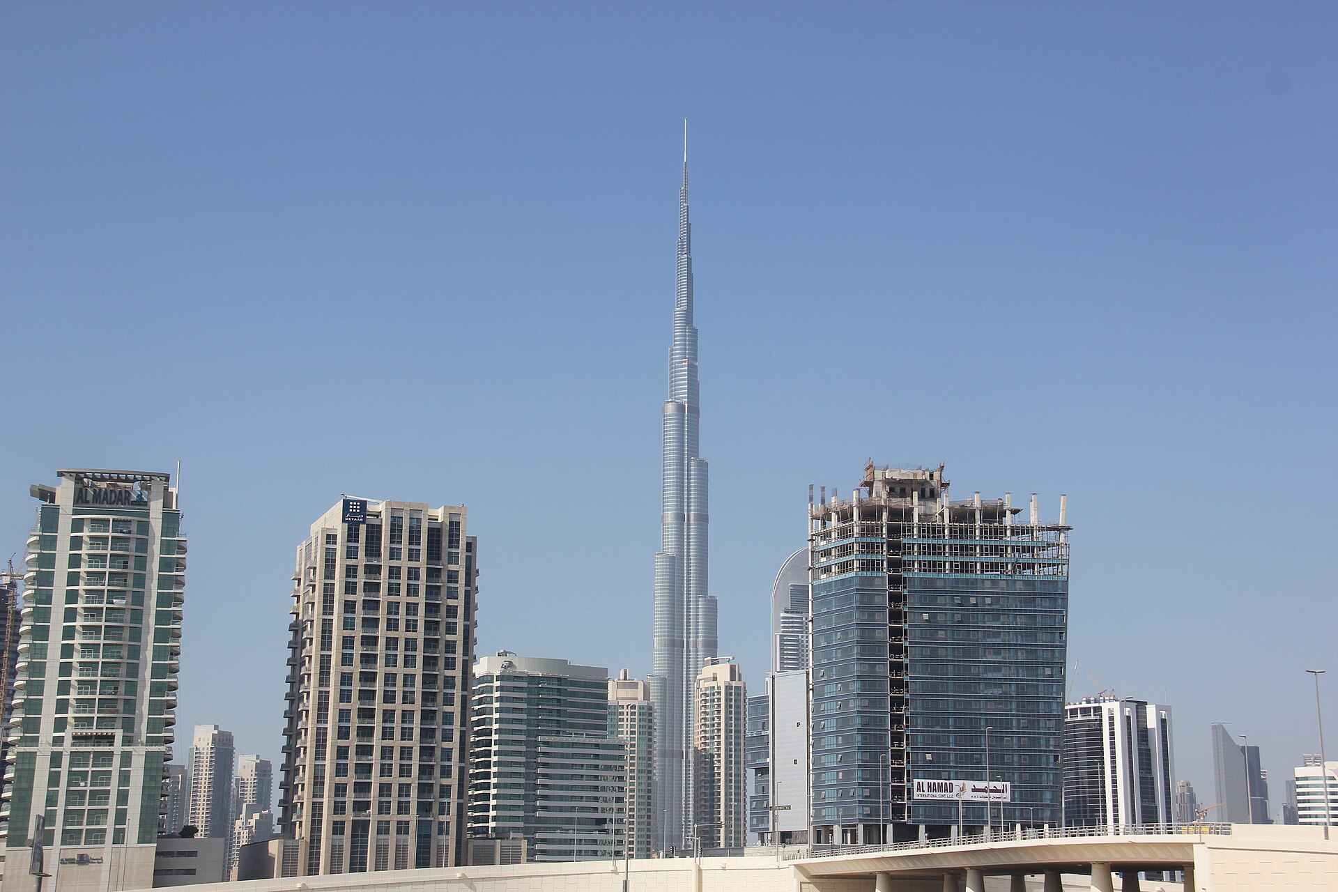 The Burj Khalifa rising above other towers in Dubai, in daylight
